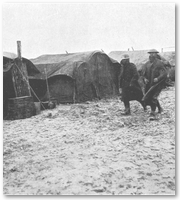 Home, Sweet Home - tents amid a muddy field.