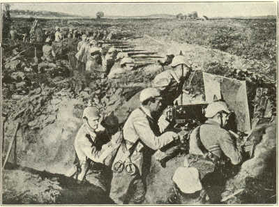 GERMAN SOLDIERS IN THEIR TRENCHES.In the foreground is an Officer superintending the sighting of a machine gun.
