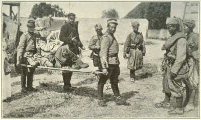 WOUNDED TURCOS BEING CARRIED IN BY FRENCH HUSSARS.