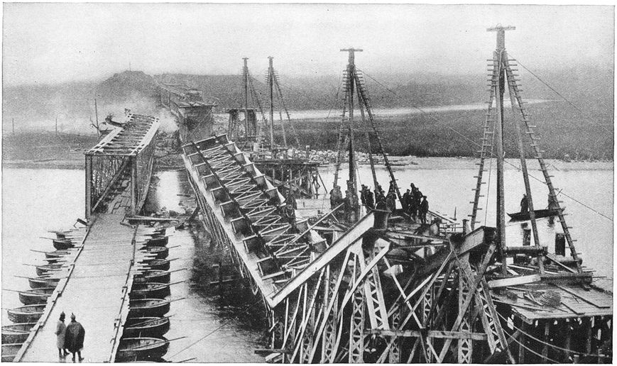 A bridge on blown up by the Russians in their retreat toward Warsaw. At the left is the pontoon bridge built by the Germans